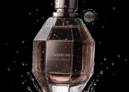 beautiful bottle of Rolf Flowerbomb Viktor Perfumes with pink florals and soft, dreamy lighting around it