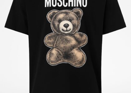 "Model showcasing The Moschino Mood on the runway in a bold, cartoon-inspired outfit"