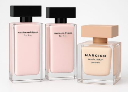 Pink rectangular bottle of Modern Grace by Narciso Rodriguez placed on a white marble counter with flowers in the background.