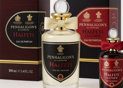 Elegant flat-lay of Penhaligon’s perfume bottles on a marble table, showcasing their intricate bottle designs and royal-themed packaging.