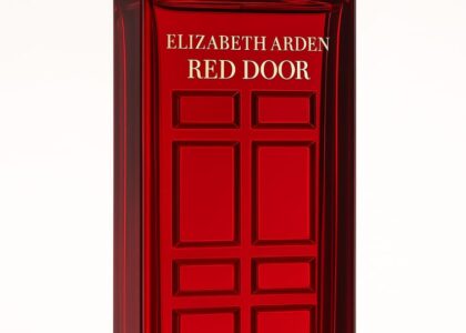 Elegant bottle of Red Door Perfume by Elizabeth Arden with red and gold packaging on a marble vanity.