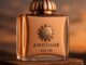 "A luxurious bottle of Amouage Interlude Man placed on a velvet surface, with golden lighting highlighting its rich blue glass."