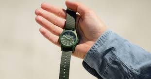 Timex Weekender watch with brown leather strap on a wooden table