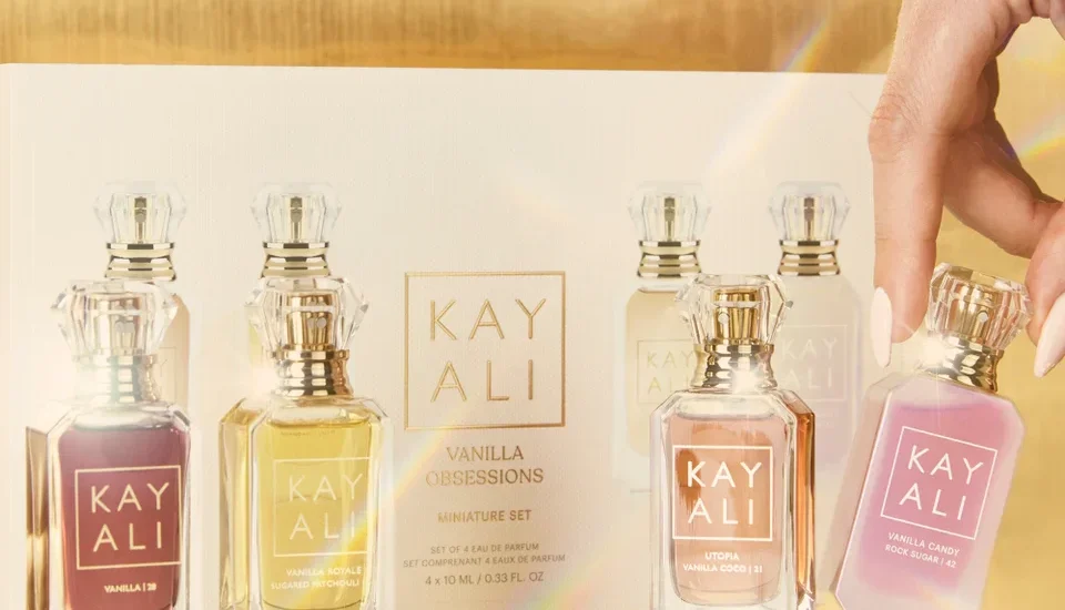 Kayali perfume bottles displayed elegantly on a vanity with soft lighting.